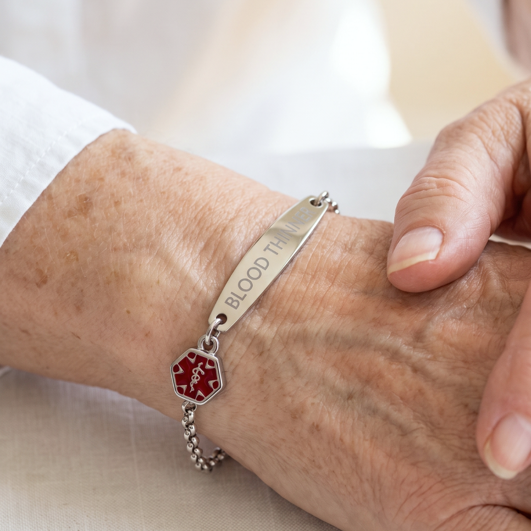 Women's blood thinner medical alert bracelet in silver worn on the wrist