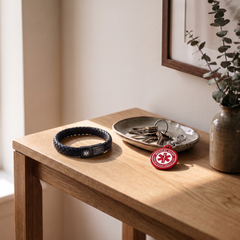 Chronic kidney disease (CKD) medical alert bracelet and keychain set on a bedside table
