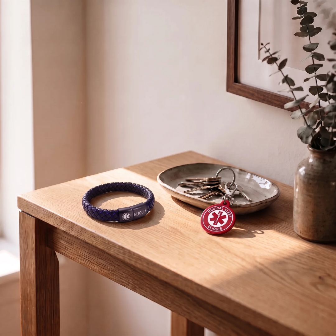 Eliquis medical alert bracelet and keychain set on a bedside table