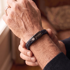 Epilepsy medical alert bracelet in black and blue worn on the wrist