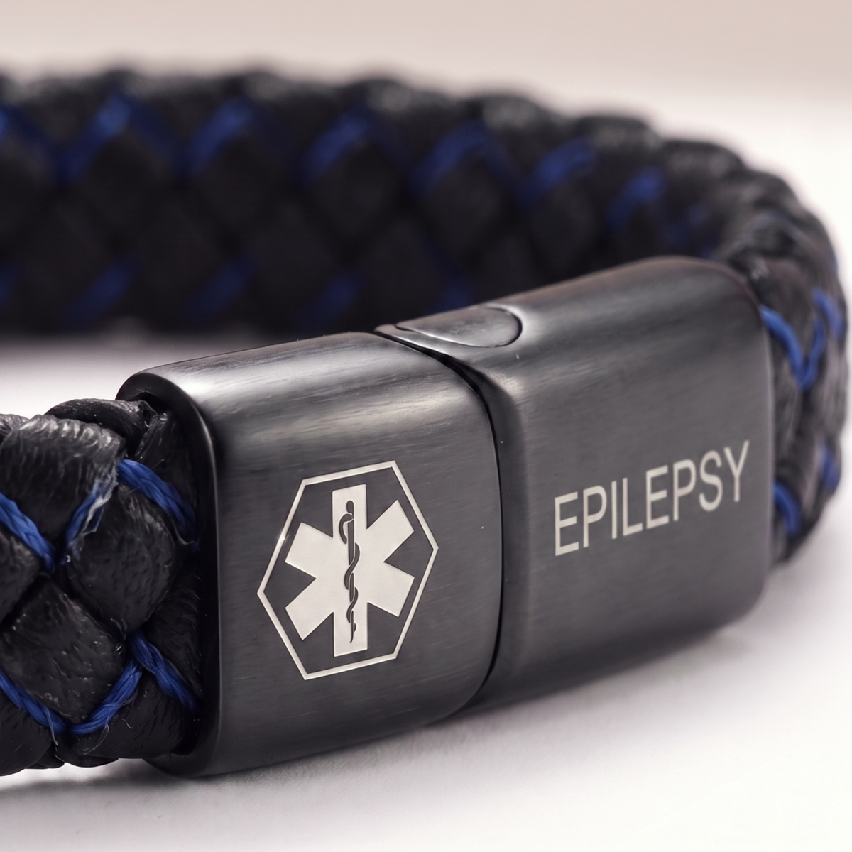 Close-up of the EPILEPSY plate on the black and blue bracelet